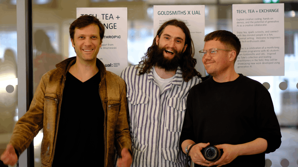 Three males pose 